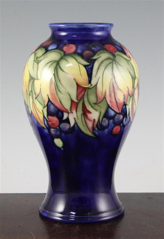 A Moorcroft leaf and berry pattern baluster vase, mid 20th century, 23.5cm (9.25in.)